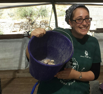 Jennifer with mosaic stones in a bucket