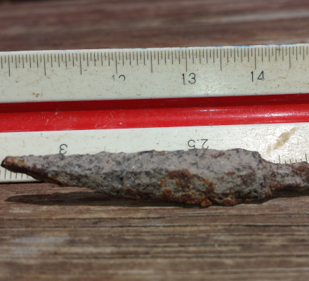 rusty arrow head with ruler measuring 5cm